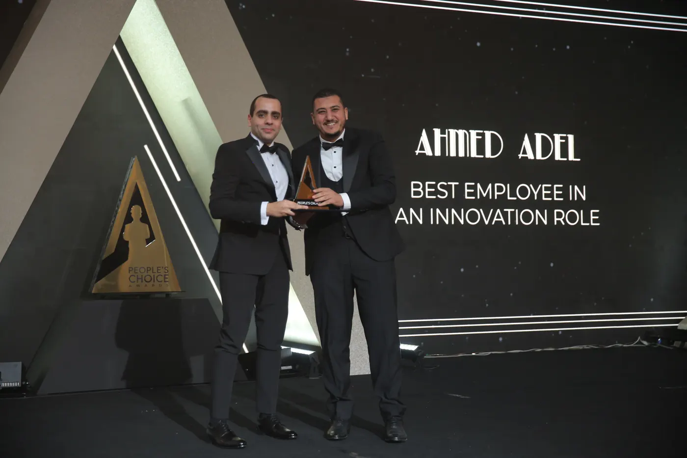 Ahmed Adel Serour receiving the Best Employee in an Innovation Role recognition on stage